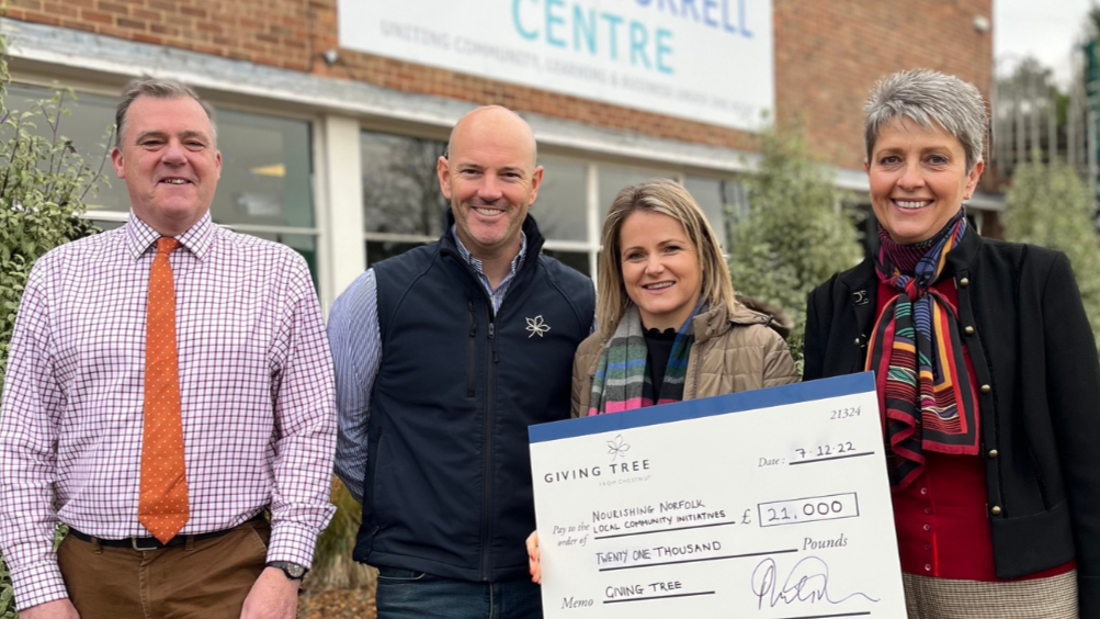 Nic from Charles Burrell Centre, Ben and Tori from Chestnut Group and Judy from Norfolk Community Foundation stand outside holding a big cheque for £21,000